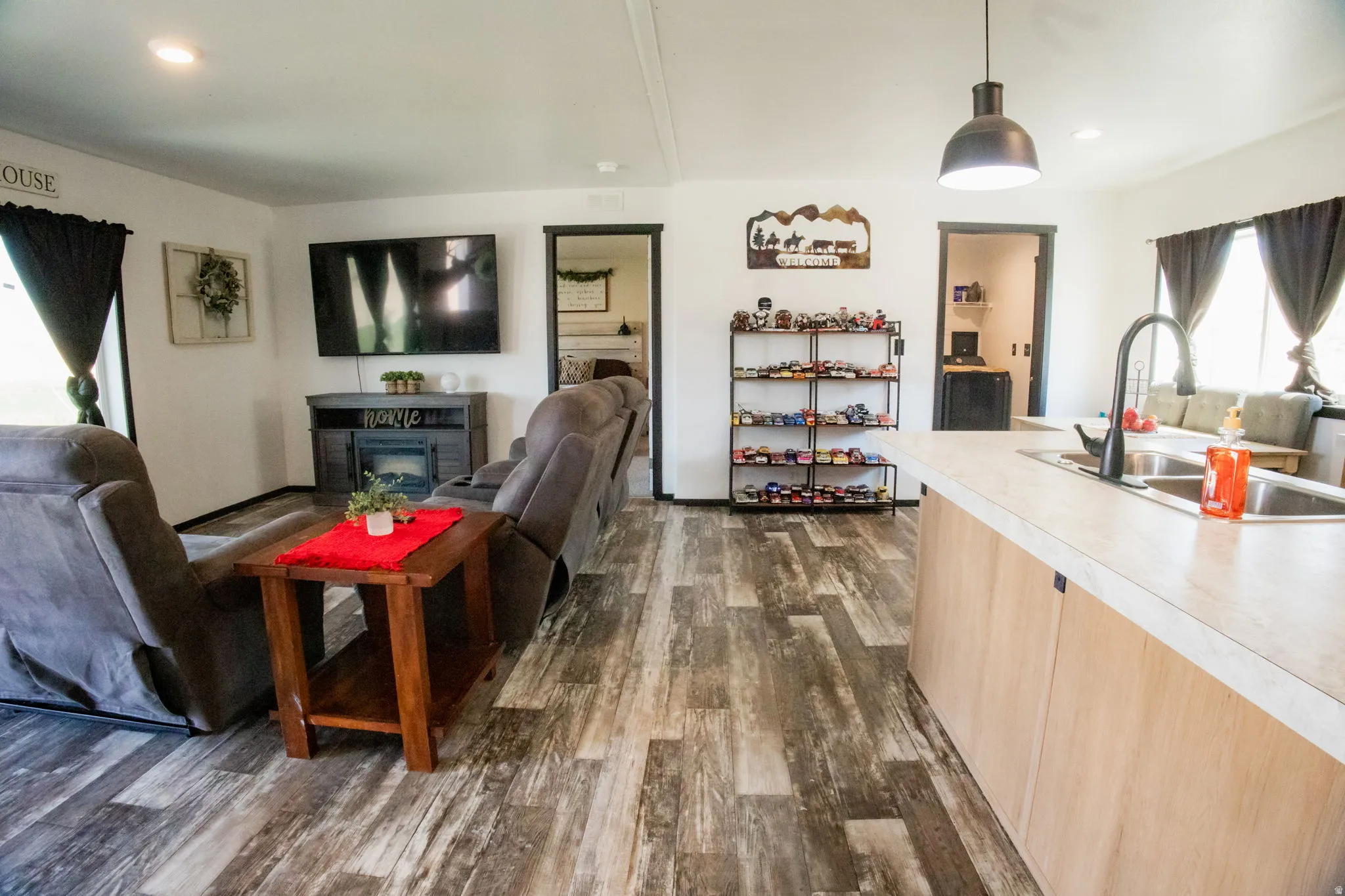 Open-concept living space featuring wood-finish flooring throughout