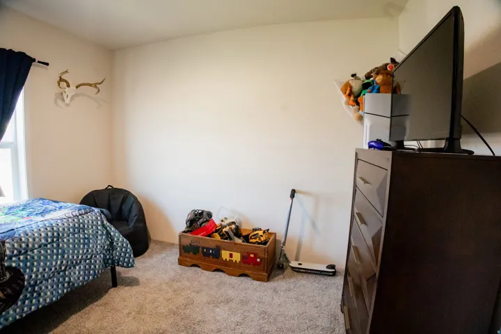 Carpeted interior room with white walls