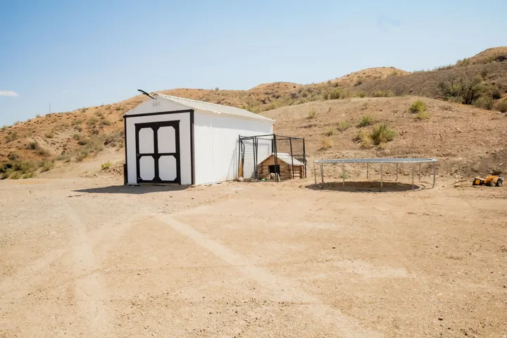 White exterior shed with black trim and double doors