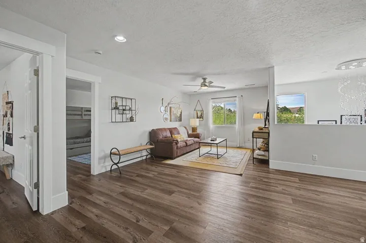 Spacious common area featuring wood-finish flooring, recessed lighting, and a ceiling fan