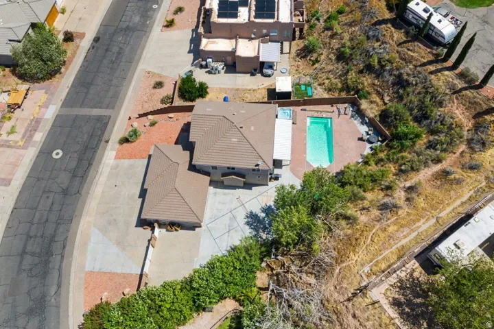 Aerial view showcasing a property with a distinct, light-colored tile roof