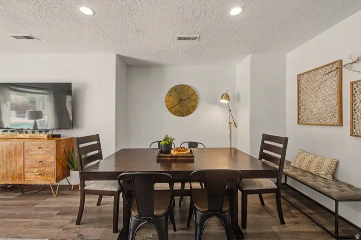 Spacious interior featuring wood-finish flooring, recessed lighting, and white wall finishes