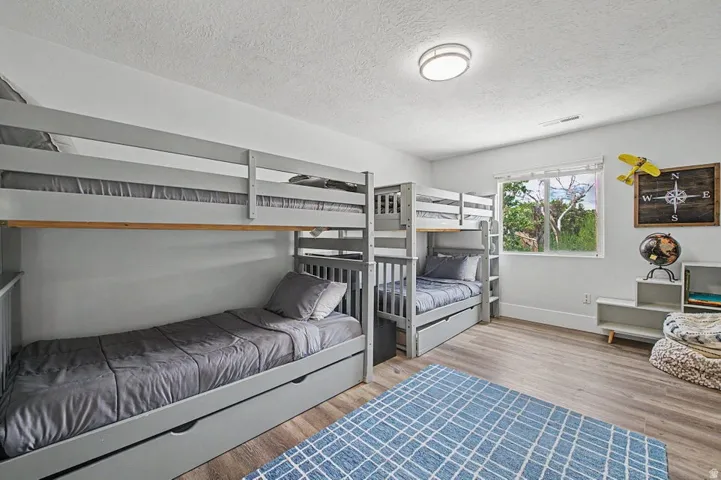 Bedroom featuring two built-in bunk beds with integrated storage drawers