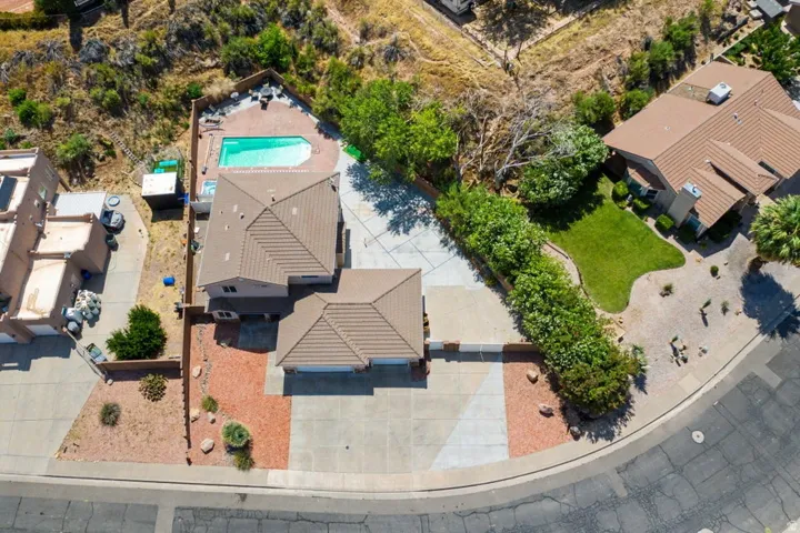 Expansive property featuring a multi-level home with a tiled roof, an integrated two-car garage, and a dedicated driveway