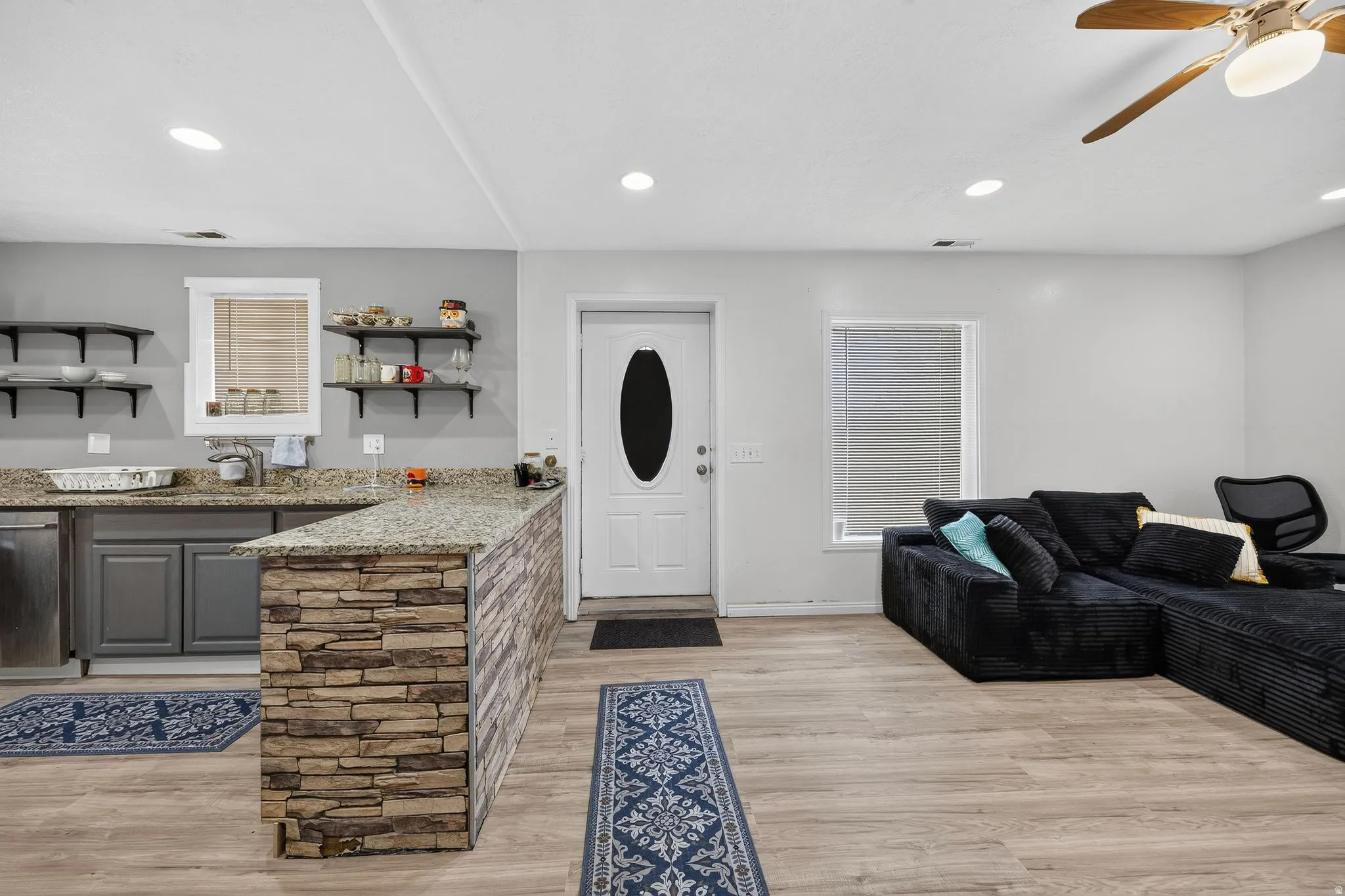 Open-concept living area featuring wood-finish flooring