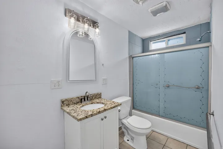 Vanity with a granite-style countertop and undermount sink
