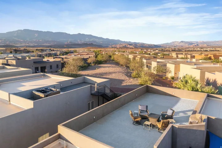 Rooftop patio featuring an outdoor seating area, a built-in spa, and a metal exterior staircase