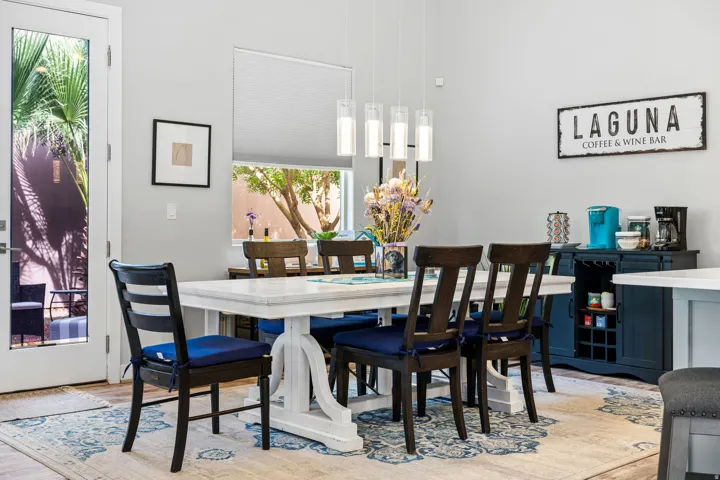 Spacious dining area featuring neutral wall paint, wood-finish flooring, and a modern rectangular chandelier