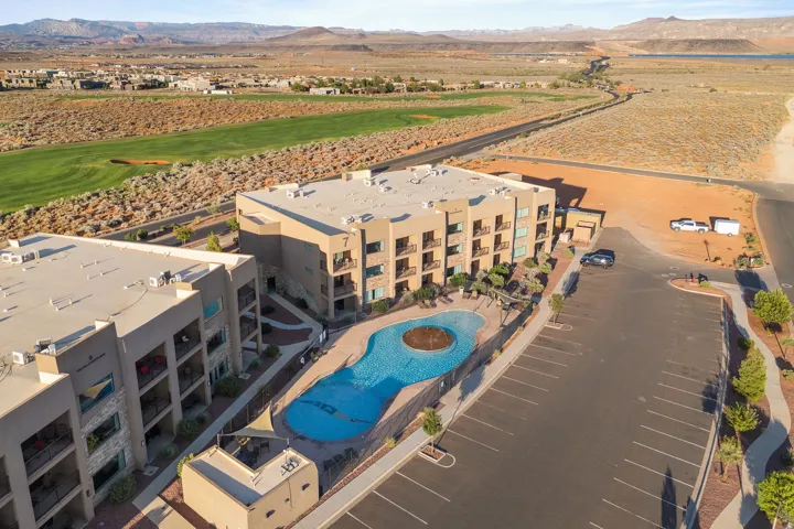 Modern multi-story buildings featuring private balconies and an outdoor swimming pool