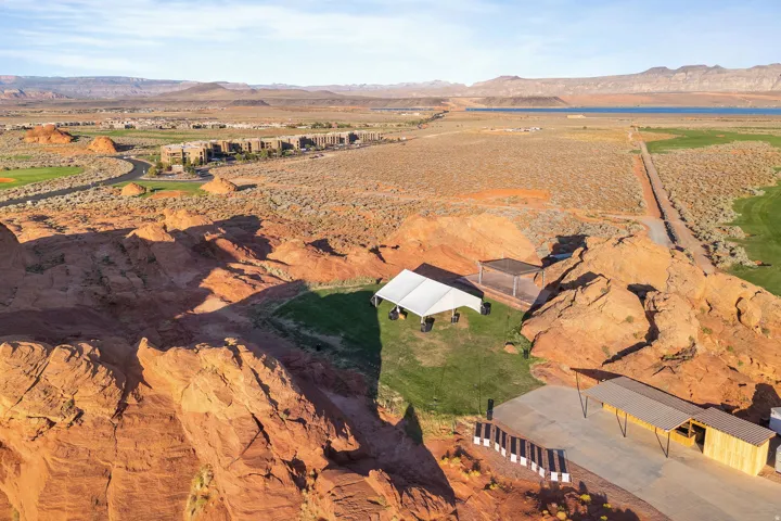 Expansive desert landscape featuring red rock formations and distant mountain ranges