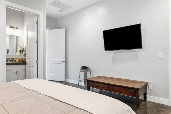 Spacious interior with dark wood-finish flooring, light grey walls, and white trim