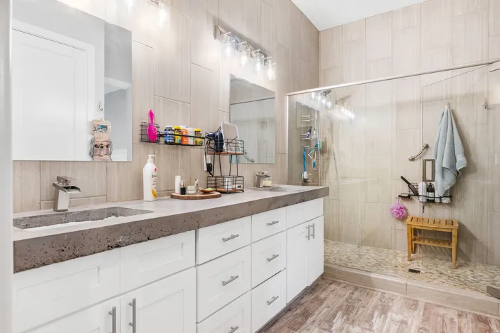 Dual vanity featuring concrete countertops with integrated sinks
