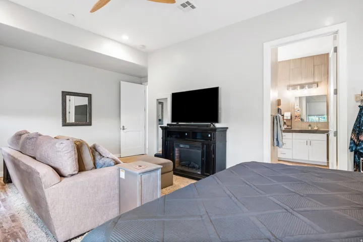 Spacious room featuring a ceiling fan, recessed lighting, wood-finish flooring, and a built-in electric fireplace