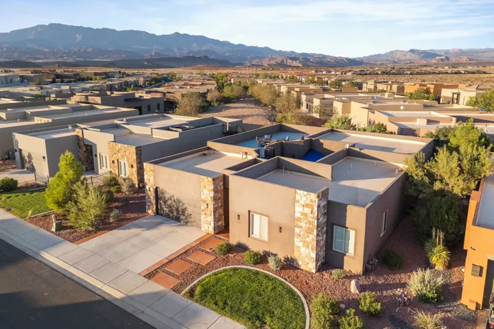 Contemporary stucco exterior with stone accents and a flat roofline