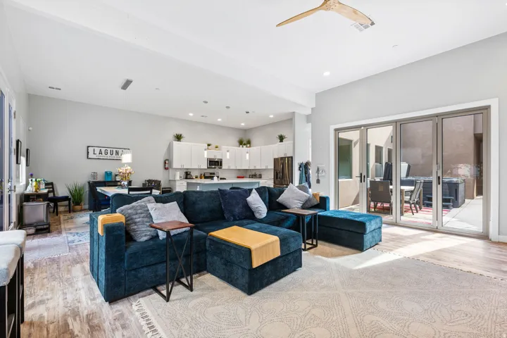 Spacious great room featuring wood-finish flooring, recessed lighting, and a modern ceiling fan