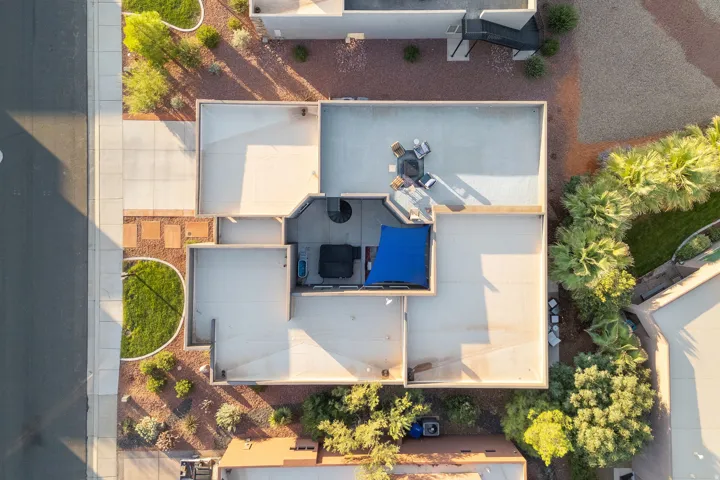 Expansive rooftop patio with a spiral staircase and multiple outdoor zones, including a shaded area with a spa