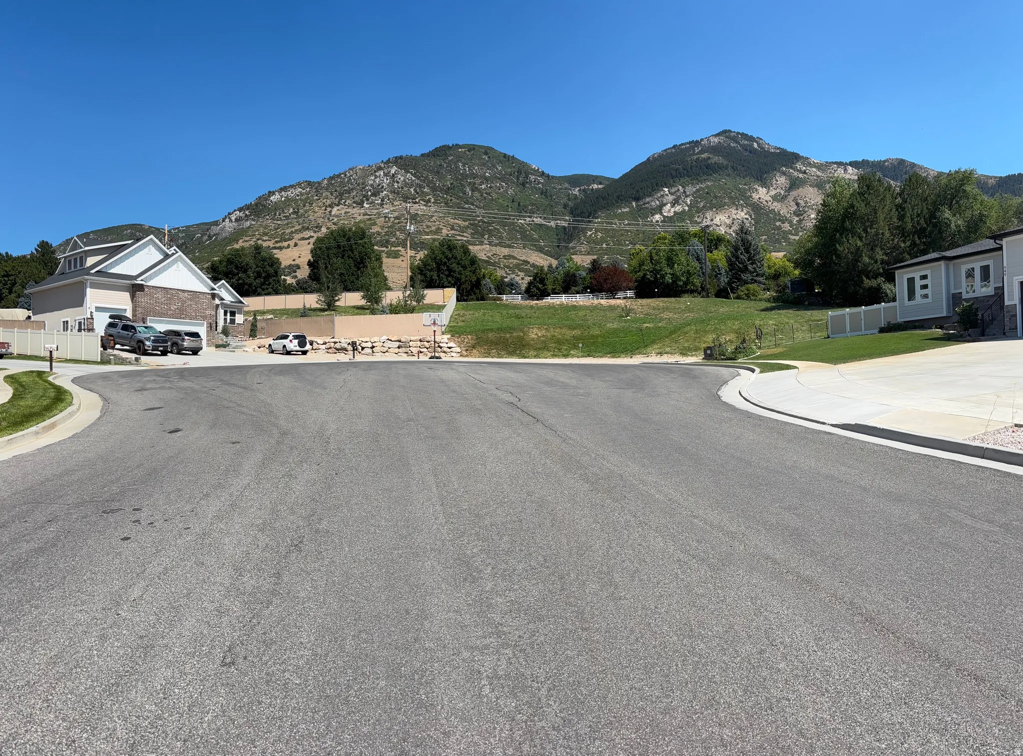 Paved cul-de-sac with concrete curbs and a surrounding residential area