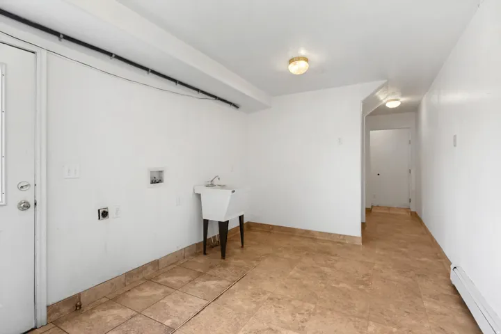 Utility room featuring light-toned ceramic tile flooring and white painted walls