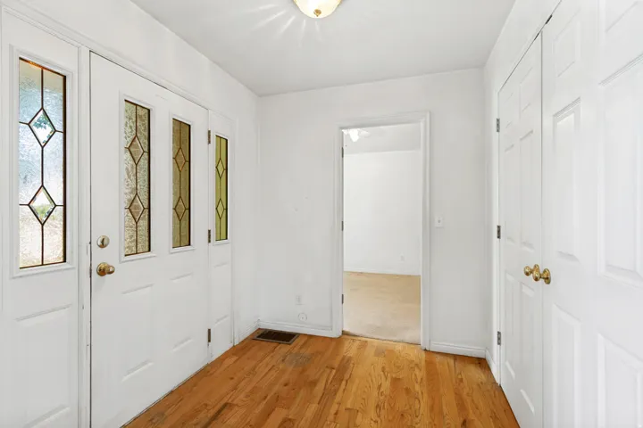 Entryway featuring wood flooring and a bright white ceiling with a flush-mount light fixture