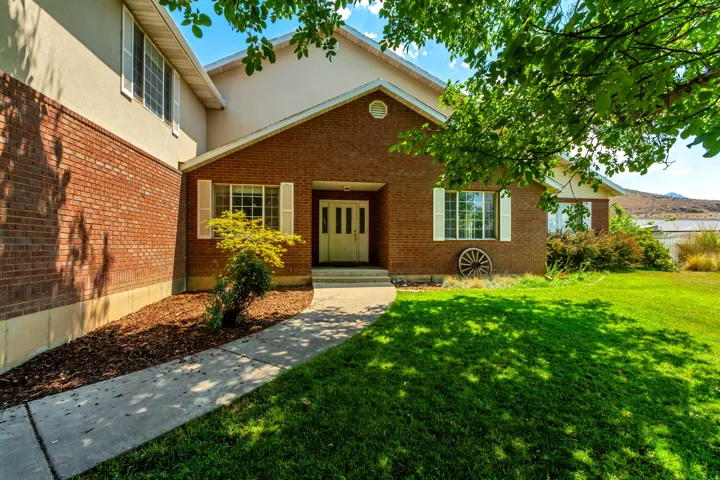 Brick and stucco exterior with white trim and shutters