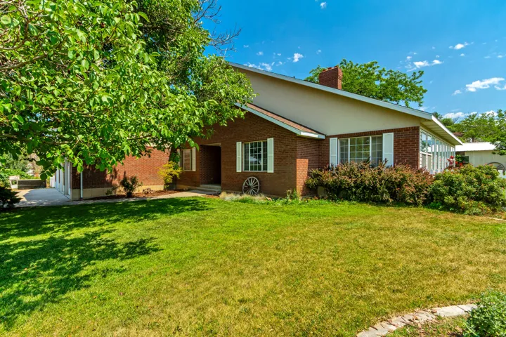 Brick exterior with white window shutters and a gabled roofline