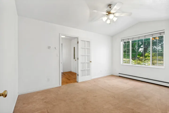 Vaulted ceiling featuring a ceiling fan with integrated lighting