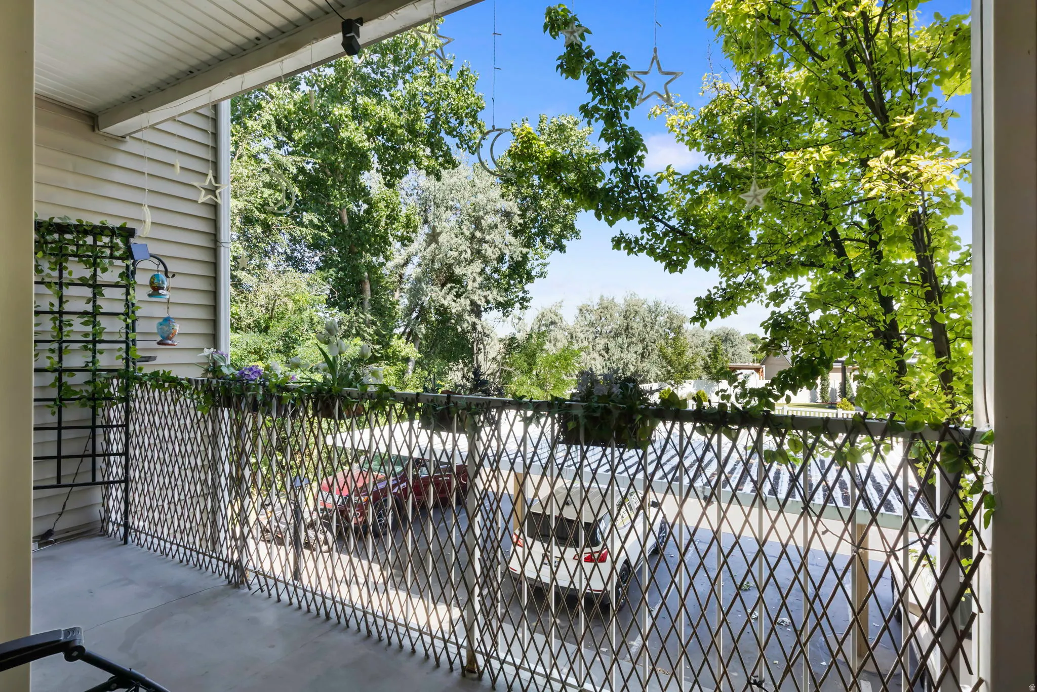 Outdoor balcony featuring a lattice-style railing and concrete flooring