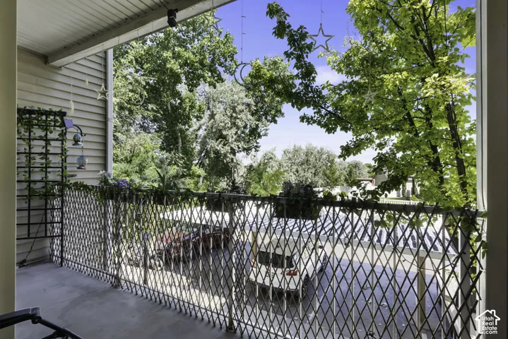 Outdoor balcony featuring a lattice-style railing and concrete flooring