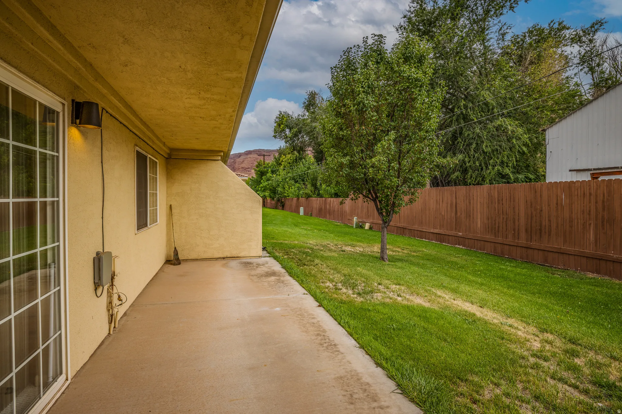 Covered patio with exterior wall lighting