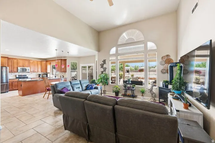 Vaulted ceilings enhance the open concept main living area featuring large picture windows with an arched transom