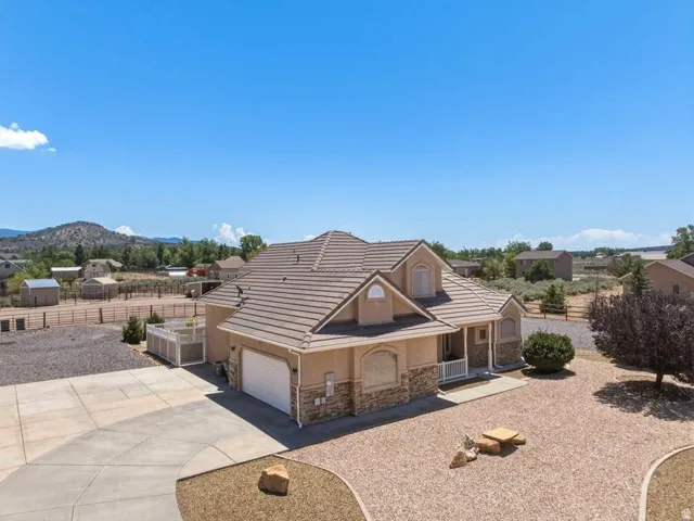 Stucco exterior with stone accents and a tiled roof