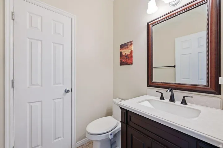 Dark wood-finish vanity with a white countertop and integrated sink