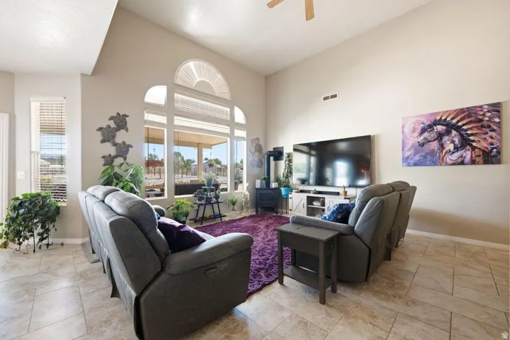 Living area featuring high vaulted ceilings and tile flooring