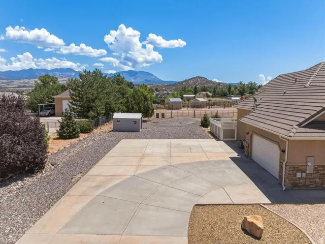 Expansive concrete driveway with gravel borders