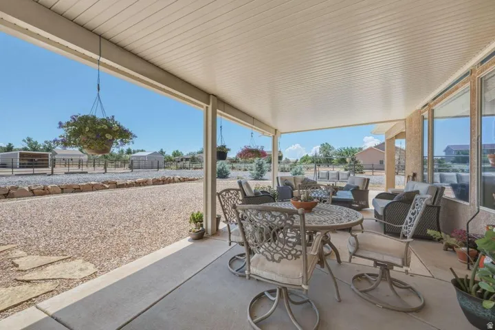 Expansive covered patio featuring a concrete surface and a paneled ceiling