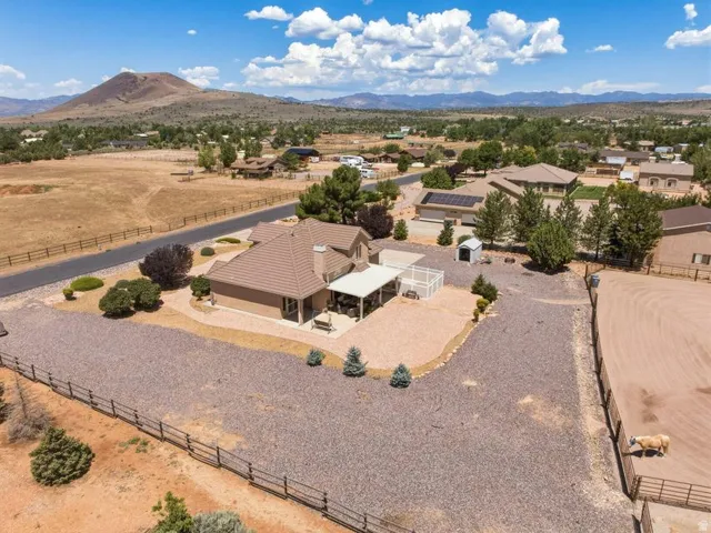 Expansive property featuring a tan stucco exterior and a tiled roof