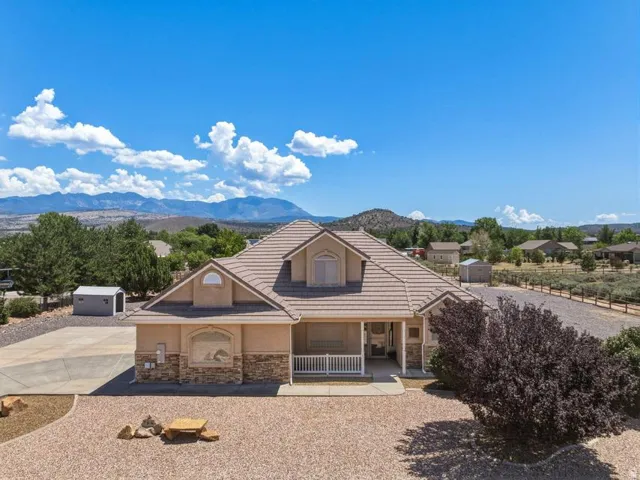 Single-story residence featuring a tile roof and stucco exterior with stone accents
