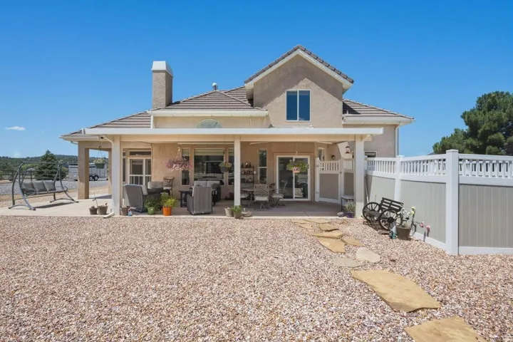 Exterior featuring a covered patio, stucco finish, and a tile roof
