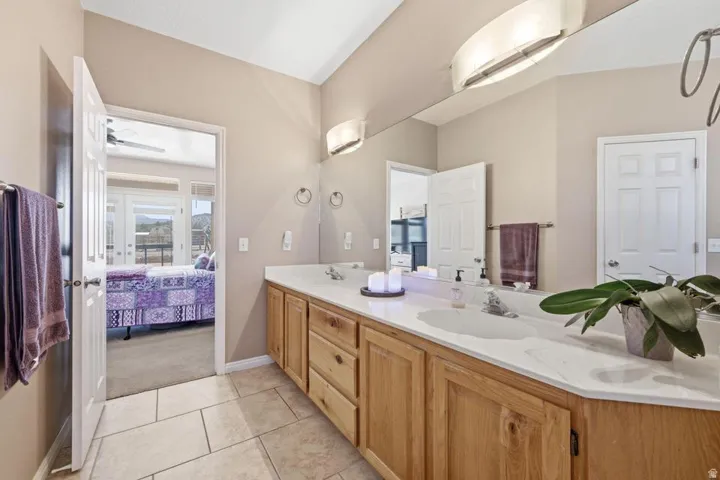 Dual vanity with wood cabinetry and light-colored countertops