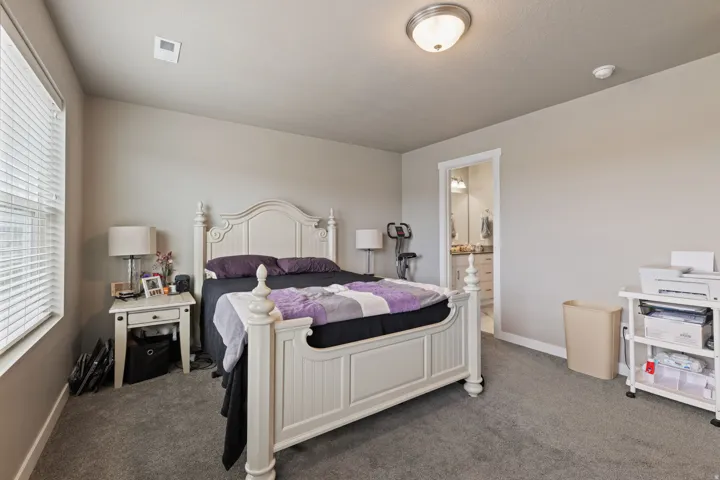 Plush carpet flooring, recessed lighting, and a window with blinds