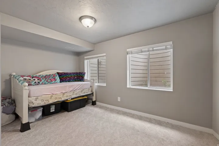 Recessed ceiling light fixture illuminates neutral painted walls and light-toned carpet