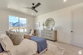 Bedroom featuring a large picture window, recessed lighting, ceiling fan, and light-toned carpeting