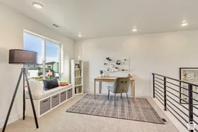 Spacious upper-level room featuring a built-in window seat with integrated storage