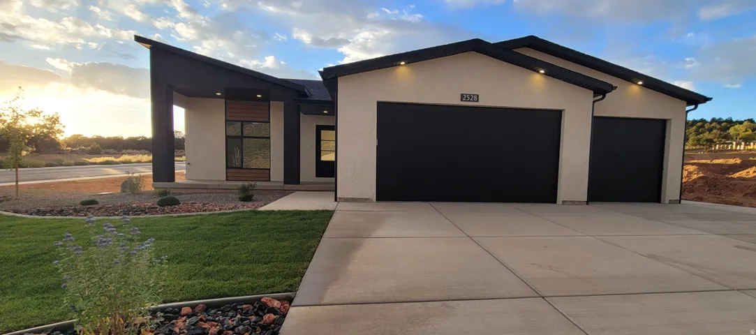 Contemporary-style residence with a two-car garage and an additional single-car garage