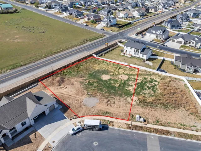 Expansive land parcel featuring defined boundaries, direct street access, and proximity to established residential properties