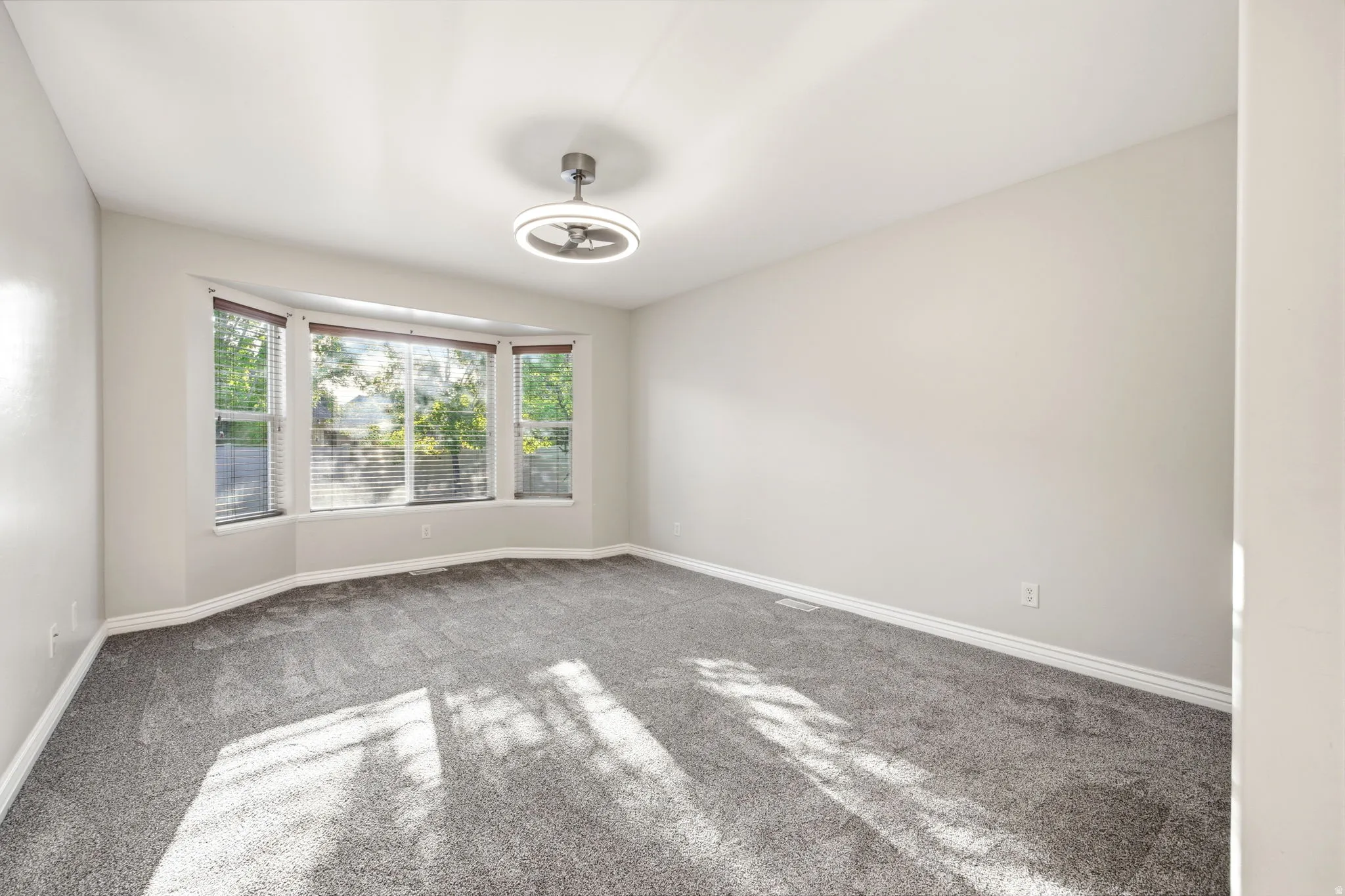 Primary bedroom with bay windows