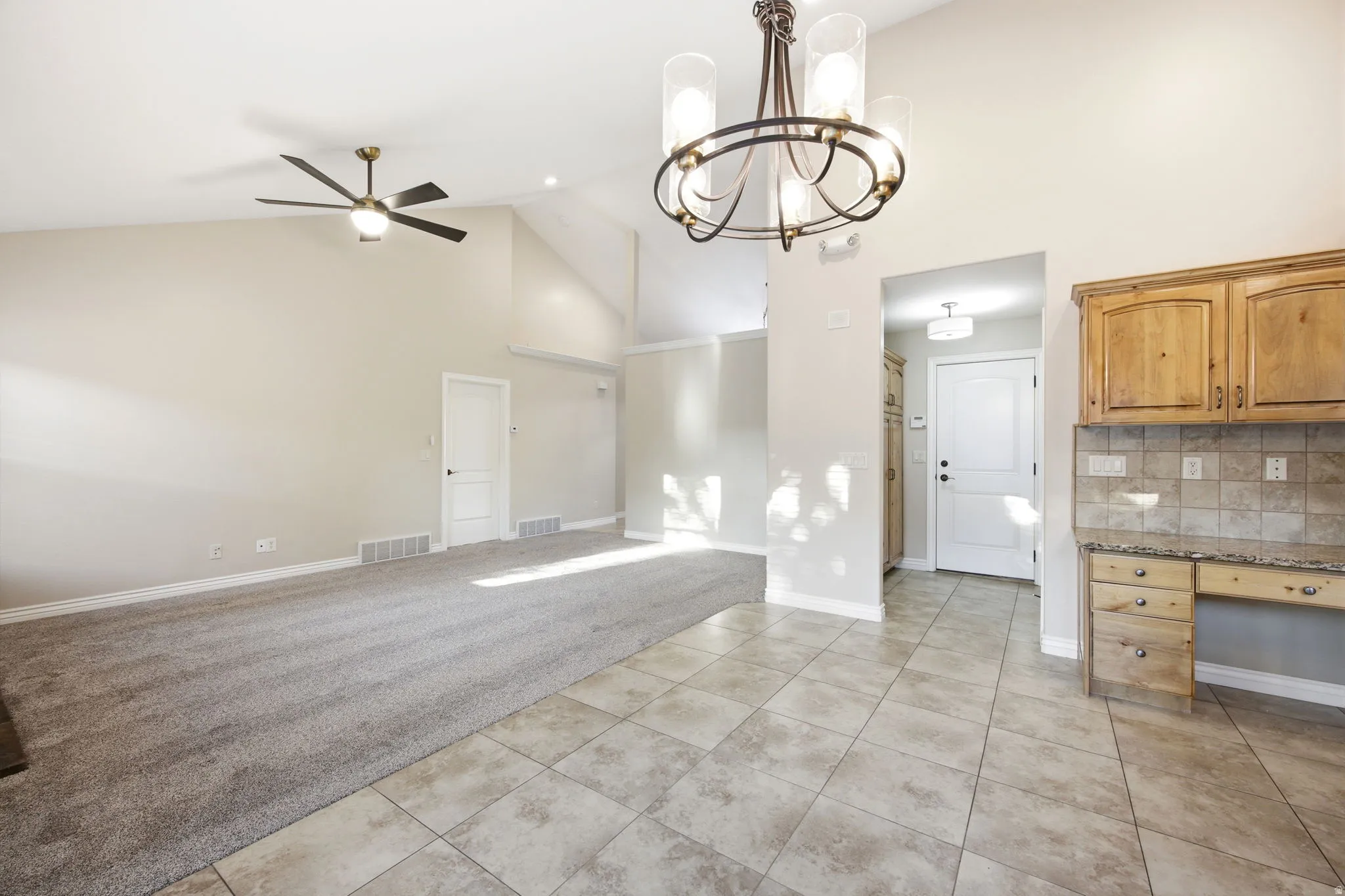 View of great room, dining room, and doorway to garage