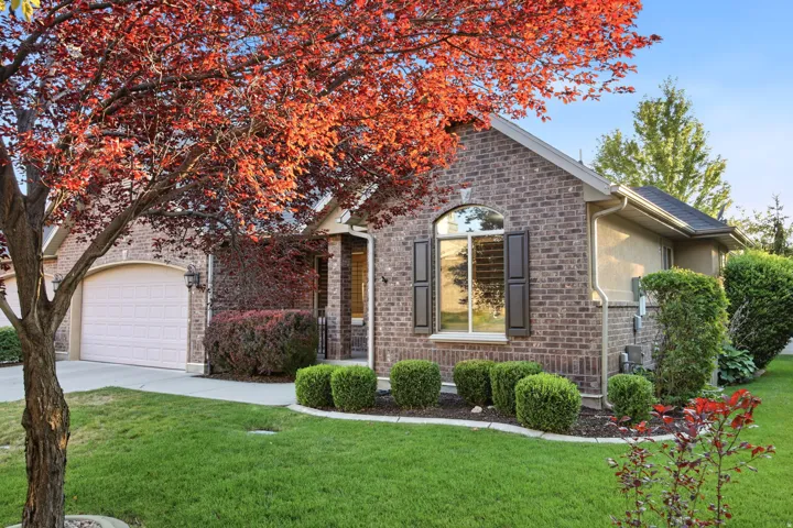 Brick exterior with an arched window featuring dark shutters