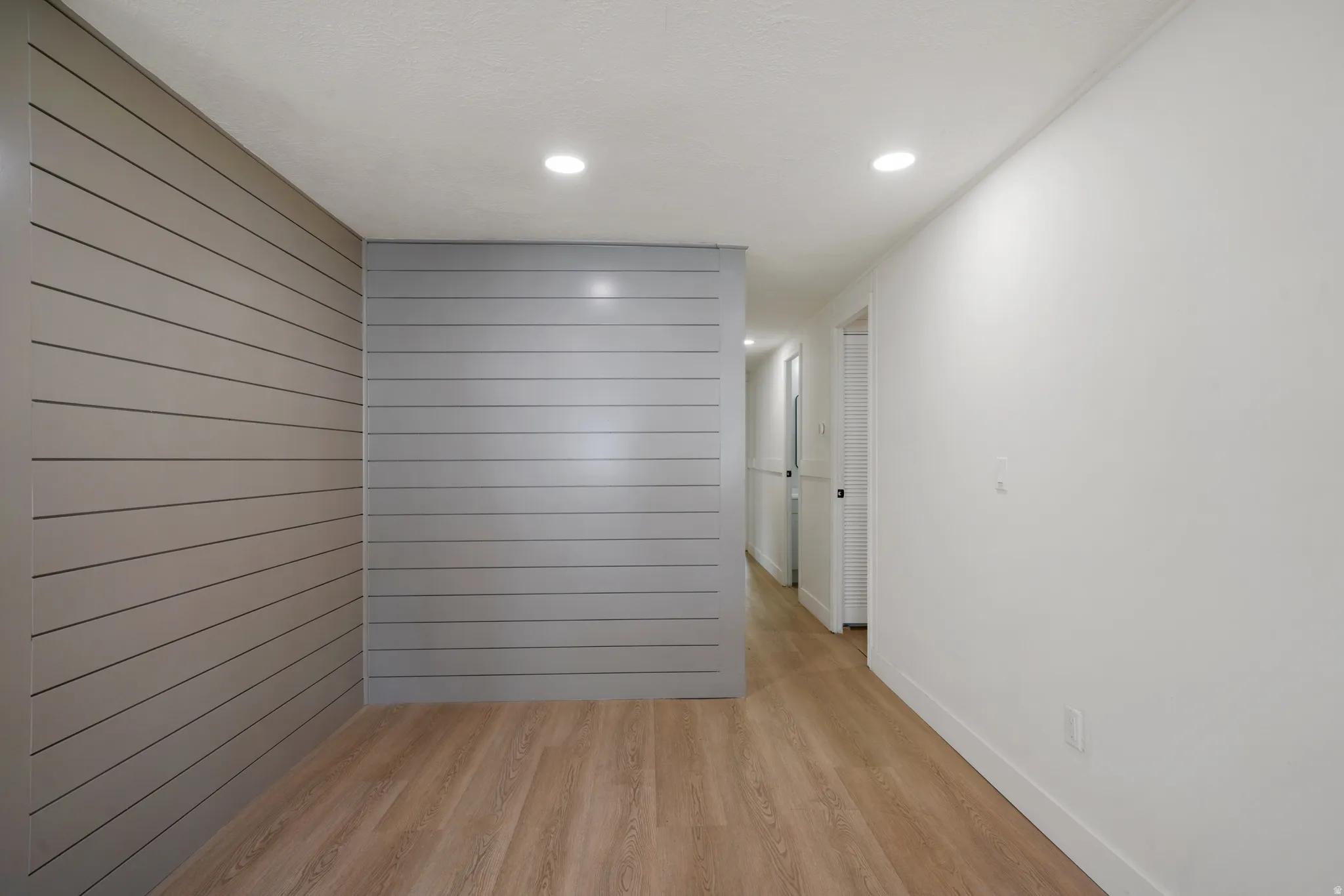 Interior space featuring light wood-finish flooring and recessed ceiling lighting