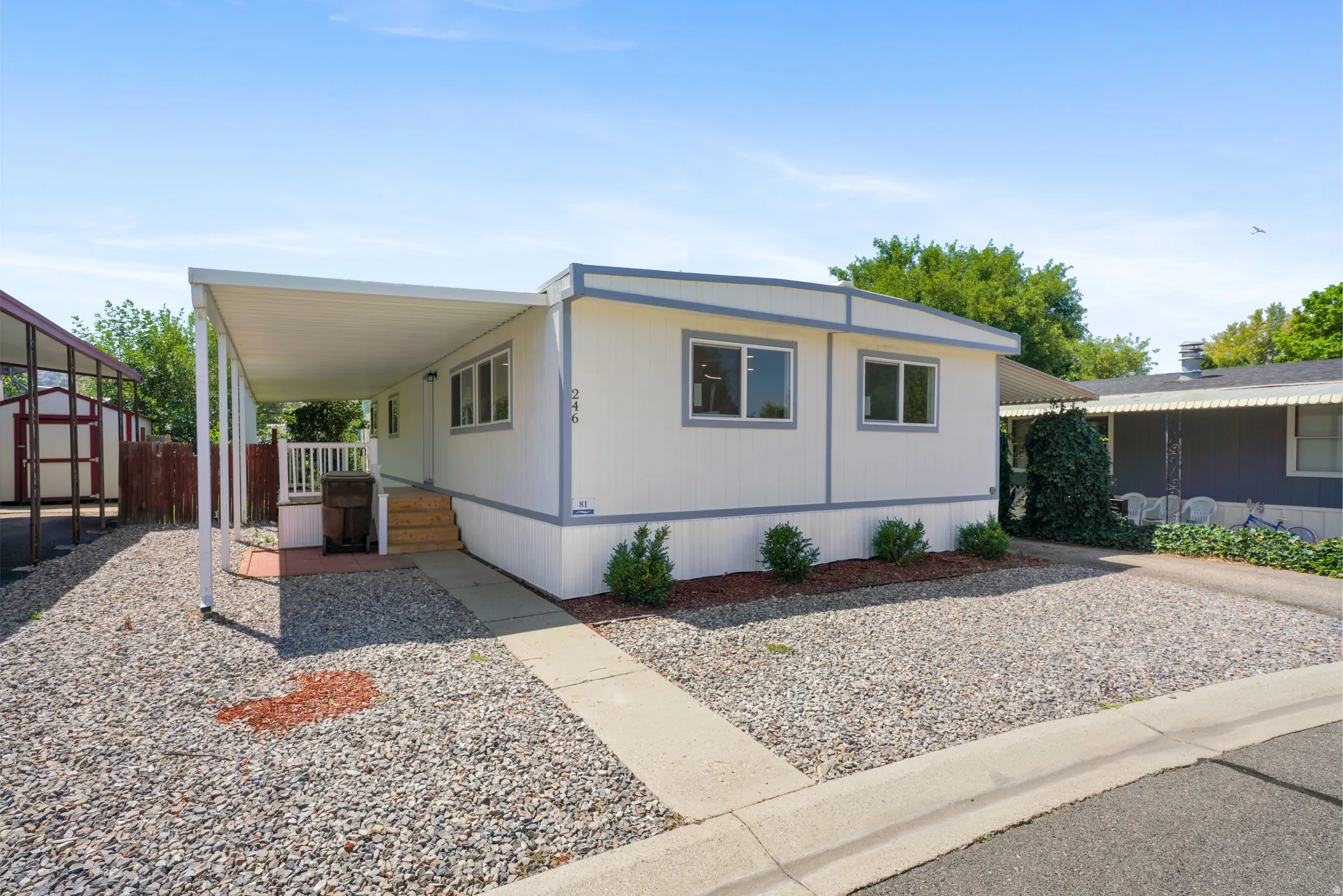 White exterior with light gray trim and multiple windows